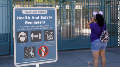 A &quot;Health and Safety Reminders&quot; sign is displayed outside the closed gates of California Adventure theme park, part of the Disneyland Resort, in Anaheim, California on Sept. 30, 2020.
