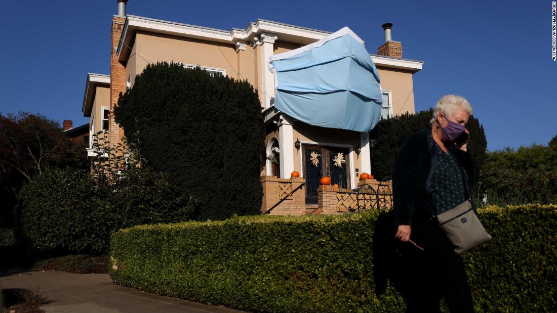 An oversized surgical mask is displayed on the front of a house in San Francisco. The homeowner put it there ahead of Halloween.
