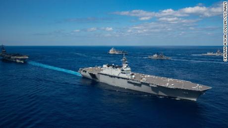 Japan&#39;s helicopter destroyer JS Kaga steams with the aircraft carrier USS Ronald Reagan during exercise Keen Sword 21.
