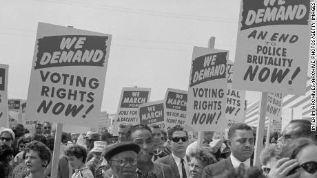 Demonstrators hold up signs calling for voting rights at the March on Washington for Jobs and Freedom on August 28, 1963, in Washington, DC. 