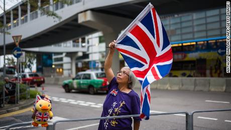 Activist Alexandra Wong waves a British Union Jack flag during a gathering outside the government headquarters to mark the fourth anniversary of mass pro-democracy rallies, known as the Umbrella Movement, in Hong Kong on September 28, 2018.  