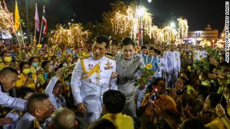 Thailand&#39;s King Maha Vajiralongkorn and Queen Suthida greet royalist supporters outside the Grand Palace in Bangkok on November 1, 2020 after presiding over a religious ceremony at a Buddhist temple inside the palace. (Photo by Jack TAYLOR / AFP) (Photo by JACK TAYLOR/AFP via Getty Images)