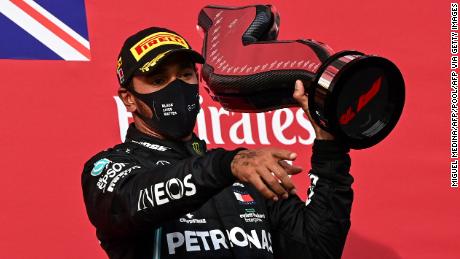 Lewis Hamilton holds his trophy as he celebrates winning the Emilia Romagna GP.