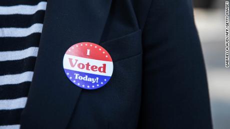 A woman wears an &quot;I Voted Today!&quot; sticker after early voting at Philadelphia&#39;s City Hall on October 7.