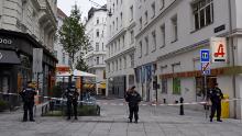 Police stand guard in Vienna city center Tuesday, a day after the attack.