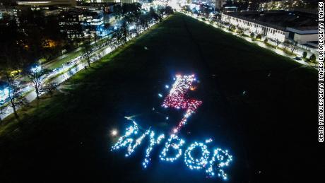 Demonstrators in Krakow use their smartphones and lanterns to spell WYBÓR (choice, in English) on Tuesday.