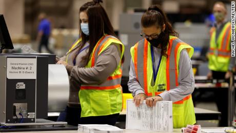 Workers whittle down piles of uncounted ballots in key states
