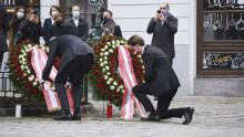 Austrian Chancellor Sebastian Kurz kneels  to lay a wreath on Tuesday near the site of the attack.