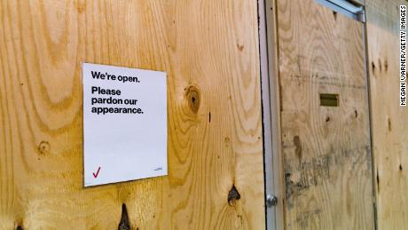 A sign hangs on the door of a boarded-up Verizon store in Atlanta on November 3, 2020.