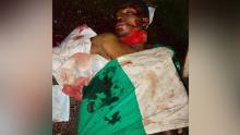 The body of Victor Sunday Ibanga is pictured in a pool of blood. 