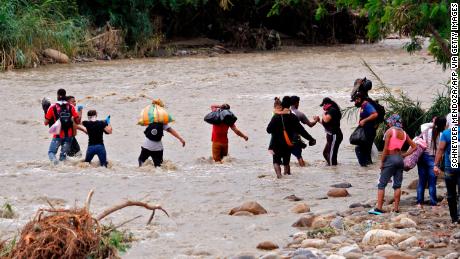 Venezuelans attempt to cross the Tachira river in Cucuta, Colombia.
