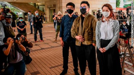 Joshua Wong, Ivan Lam and Agnes Chow arrive for their trial at West Kowloon Magistrates Court in Hong Kong on November 23, 2020.
