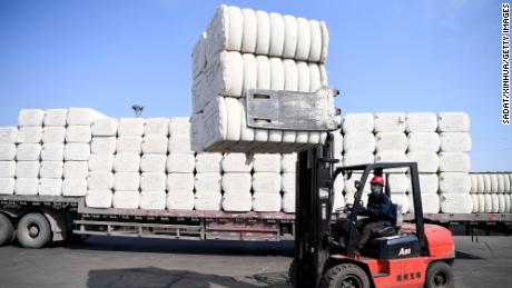CHANGJI, March 19, 2020 -- A staff member loads cotton at the Asia and Europe international logistics park in Changji, northwest China&#39;s Xinjiang Uygur Autonomous Region, March 19, 2020. Enterprises resumed work in an orderly manner at the Asia and Europe international logistics park with measures to prevent infections of COVID-19.(Photo by Sadat/Xinhua via Getty Images)