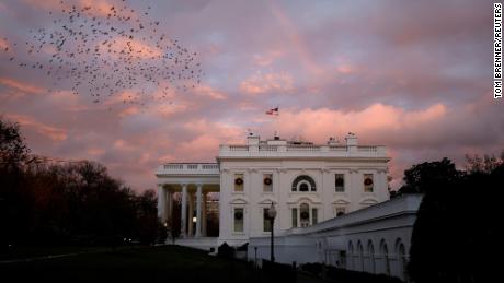 A rainbow appears over the White House as birds fly nearby following a storm in Washington, U.S., November 30, 2020. REUTERS/Tom Brenner     TPX IMAGES OF THE DAY