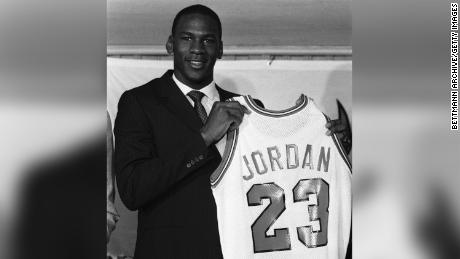 Michael Jordan holds up his Chicago Bulls jersey at the 1984 news conference in which the Bulls announced his signing.