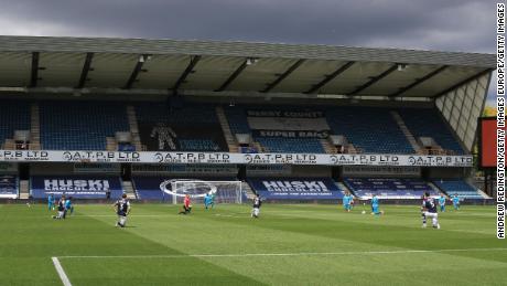 Players take a knee prior to kick-off during the Championship match between Millwall and Derby.