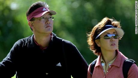BJ Wie (left) and his wife Bo Wie watch their daughter during practice for the 2004 Curtis Cup Matches.