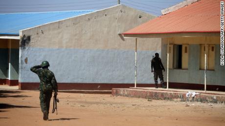 Nigerian soldiers walk inside the school on December 15, where gunmen abducted students in Kankara, Nigeria.