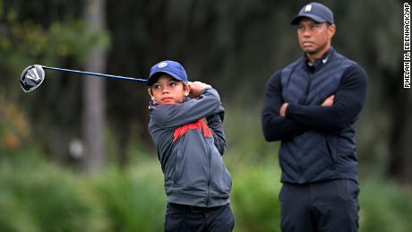 Tiger Woods watches as his son Charlie tees off.