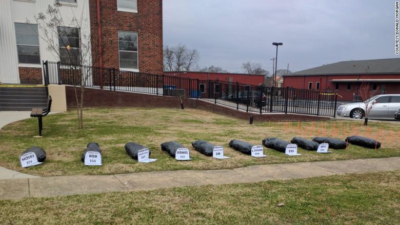 Group of Alabama protesters places fake body bags on courthouse lawn to push for removal of Confederate flag and monument
