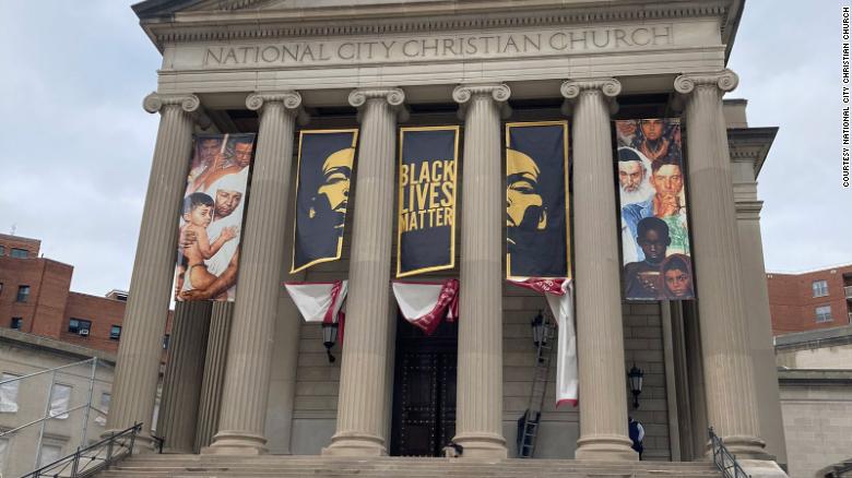 A church installs a Black Lives Matter banner ahead of pro-Trump protests in Washington, DC