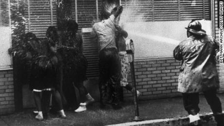 Firemen train their hoses on a group of African Americans while routing anti-segregation demonstrators in Birmingham, Alabama, in May 1963.