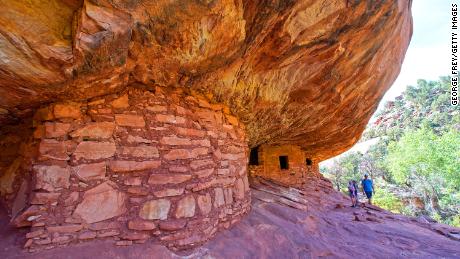 Hikers look around the House on Fire Indian ruins in Mule Canyon, which is part of the Bears Ears National Monument.