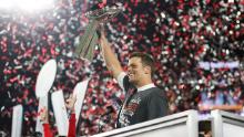 Tom Brady holds the Vince Lombardi Trophy after leading the Tampa Bay Buccaneers to a Super Bowl win in February 2021.