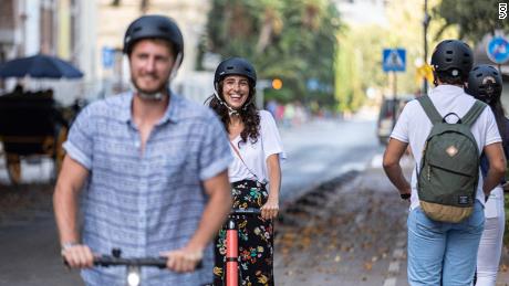 Cities should make roads safer for e-scooters, deterring riders from using the sidewalk, says the International Transport Forum. 