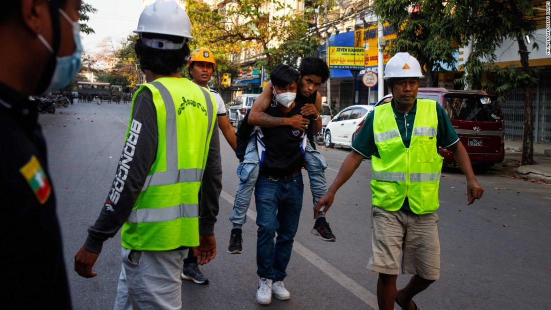 Medics clear the way as an injured protester is carried away for treatment in Mandalay, Myanmar, on February 15.