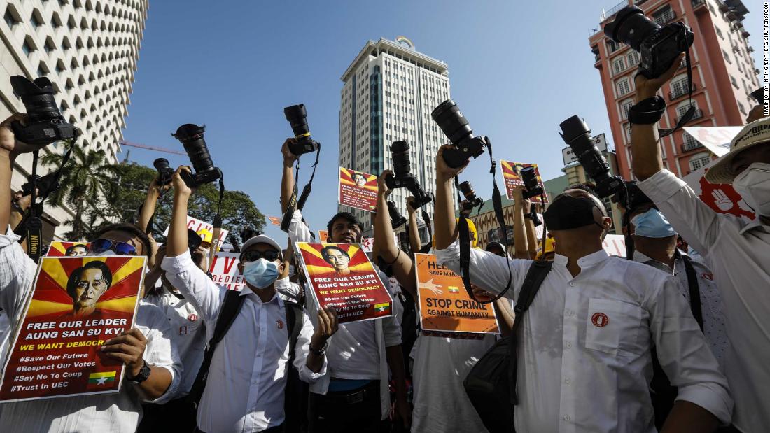 Members of the Myanmar Photographers Association hold up their cameras as they call for Suu Kyi&#39;s release on February 13.