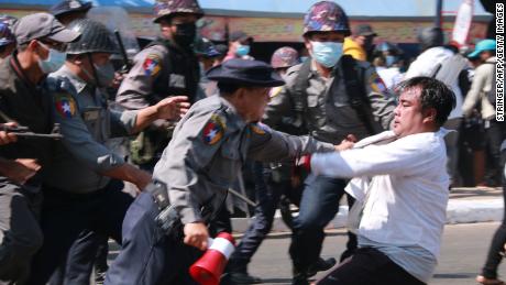 Police arrest a protester during a demonstration against the military coup in Mawlamyine, Mon State on February 12.