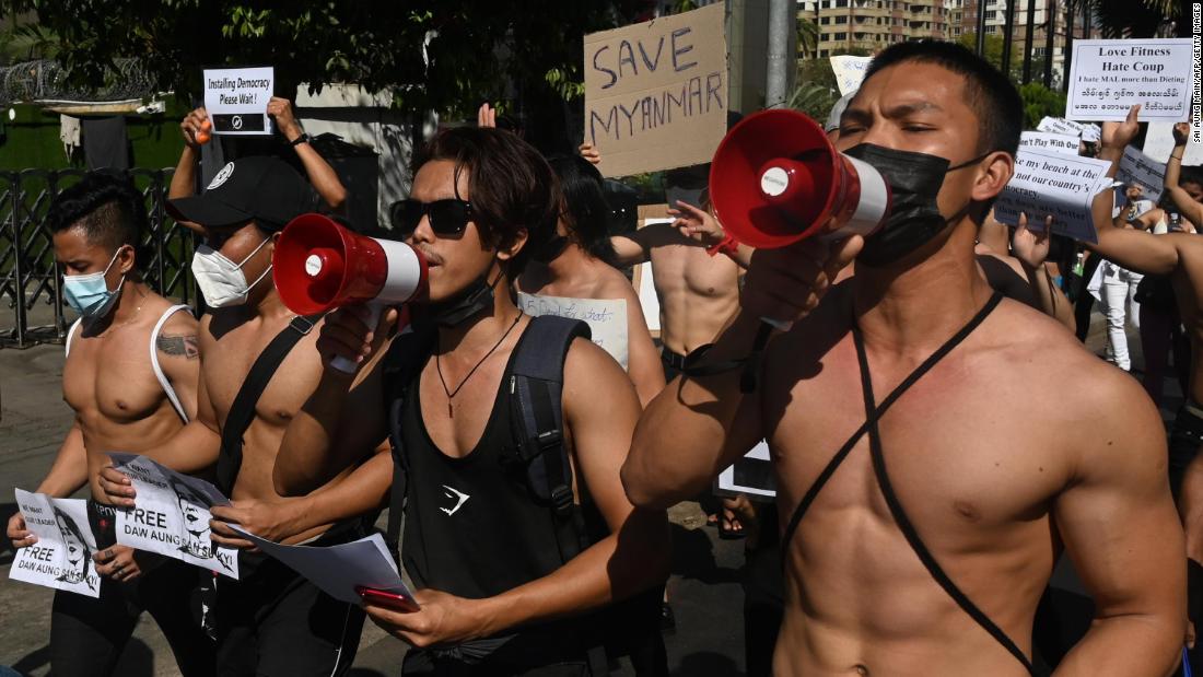 Bodybuilders take part in a protest in Yangon on February 11.