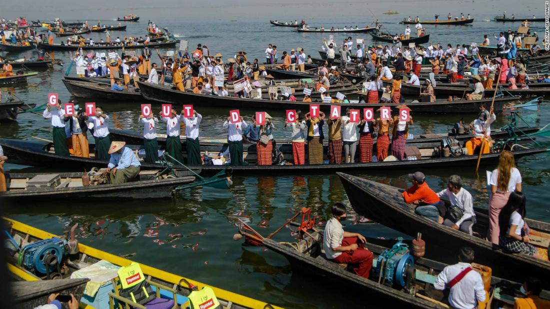 People hold up letters that spell &quot;get out dictators&quot; during a demonstration at Inle Lake on February 11.