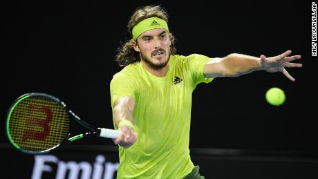 Tsitsipas hits a forehand return to Medvedev during their semifinal match.