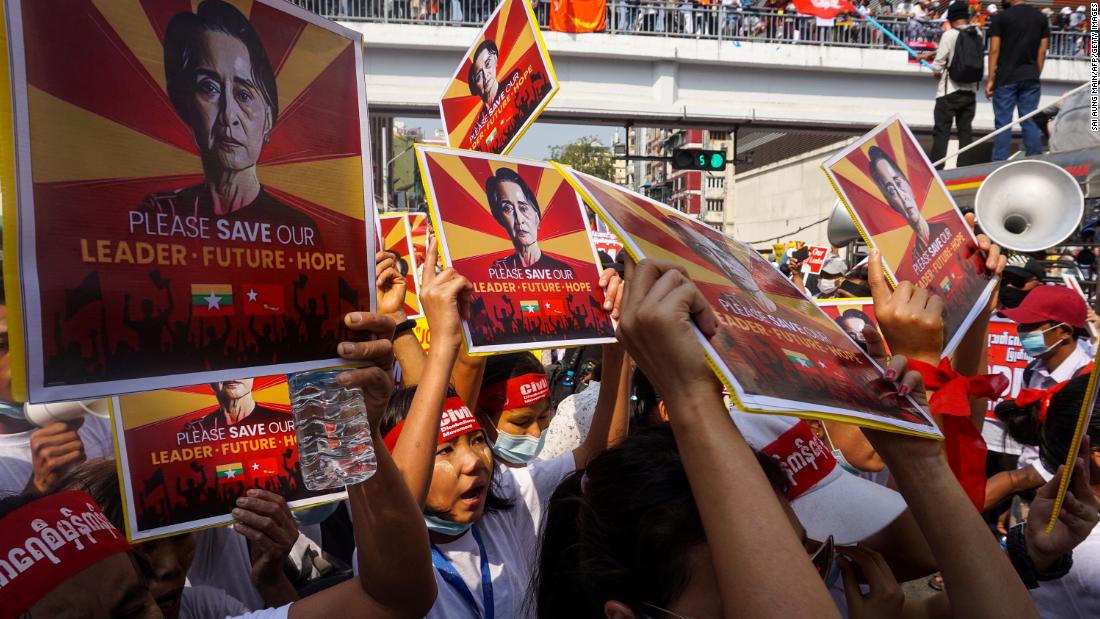 Protesters hold signs featuring civilian leader Aung San Suu Kyi during a demonstration in Yangon on February 22. 