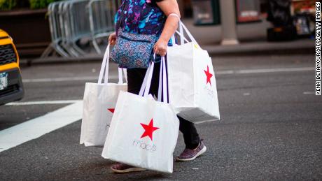 A shopper carries bags as she leaves Macys department store in New York on Black Friday, November 27, 2020. - The coronavirus is clouding &quot;Black Friday&quot; much as it has overshadowed 2020 in general, but some leading experts still expect strong overall sales even as shopping patterns are altered. (Photo by Kena Betancur / AFP) (Photo by KENA BETANCUR/AFP via Getty Images)