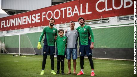 Liverpool goalkeeper Alisson (R) and brother Muriel (L) with father Jose Becker (2-R).