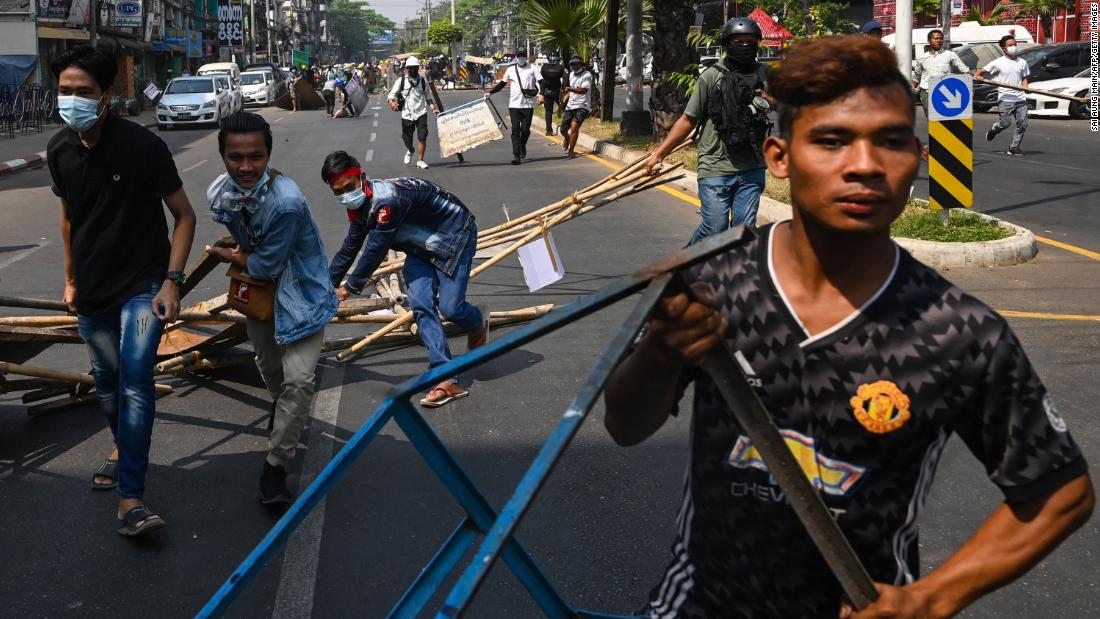 Protesters erect barricades during a demonstration in Yangon on February 28.