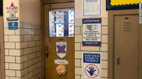 New signs encouraging practices to prevent the spread of Covid-19 are posted next to a &quot;Welcome&quot; decoration for first-graders at Hawthorne Scholastic Academy in Chicago.