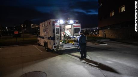 A paramedic loads a cleaned stretcher onto the back of an ambulance before heading out for another call. The pandemic has only exacerbated decades-long trends in American death rates described in a new report.
