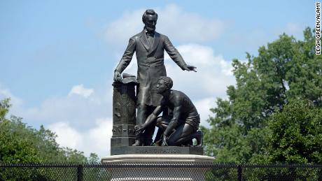 The controversial Emancipation Memorial on Capitol Hill in Washington. Some say its depiction of Lincoln looming over a slave is demeaning. The statue is protected by a fence to keep out protesters.