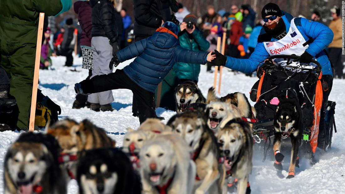 Seavey leans over for a high-five at the start of the race.