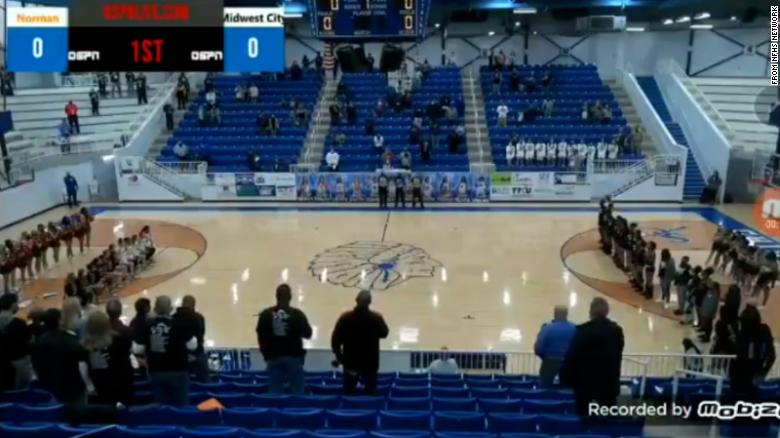 An announcer hurled racial insults at a high school basketball team for kneeling during the National Anthem