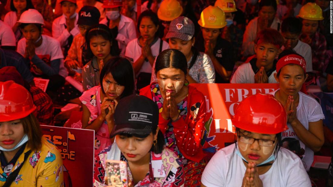 Anti-coup protesters pray in Yangon on March 14.
