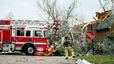 A firefighter surveys damage after a tornado touched down in the Eagle Point community near Birmingham. Alabama. 