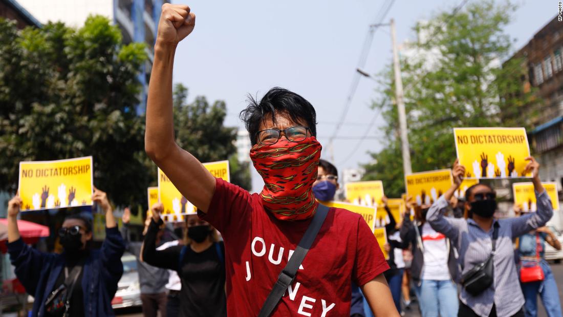 Protesters gesture during a march in Yangon on March 26.