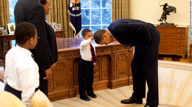 Obama congratulates boy who touched his head in iconic photo on graduating high school