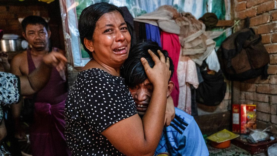 People cry in Yangon after a relative was shot during a crackdown on anti-coup protesters.