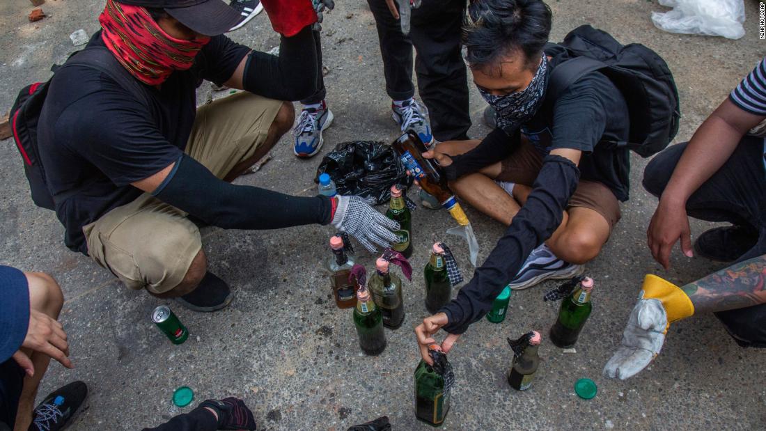 Protesters make incendiary devices during an anti-coup rally in Yangon.
